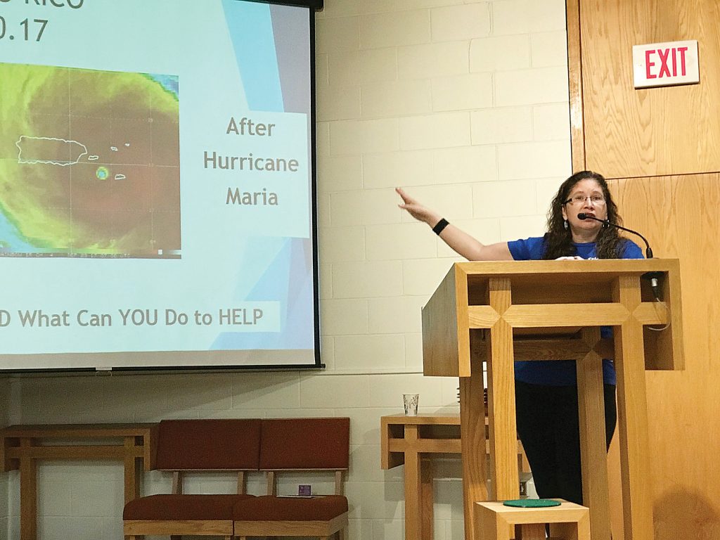 Maria Delgado Sutton, organizer of Puerto Rico One Box at a Time campaign, talks to parishioners at Trinity Emmanuel Lutheran Church in Gates about the extent of damage to Puerto Rico after it was hit by Hurricane Maria, a category 4 storm, last September. The church has adopted Puerto Rico One Box at a Time as their annual mission project. Provided photo