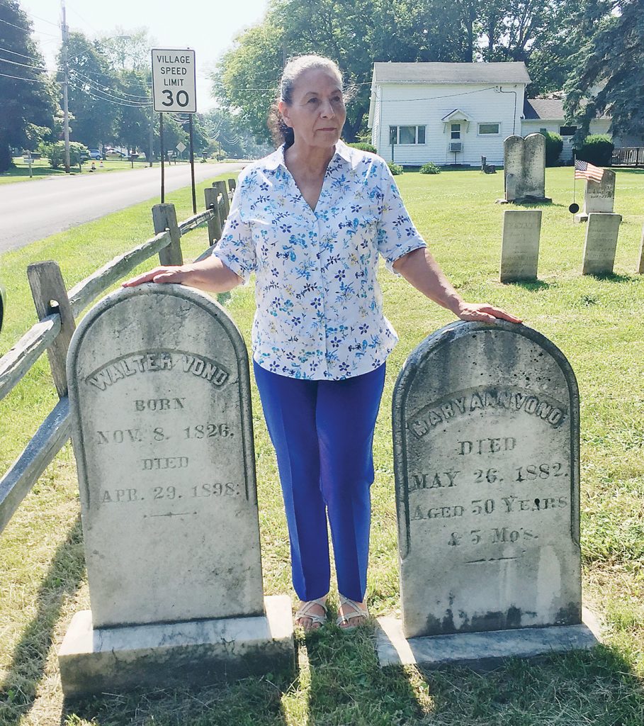 Lonie Wilson by the graves of Walter and Mary Vond. This was the first known visit to the area by Vond family members since 1898. Provided photo