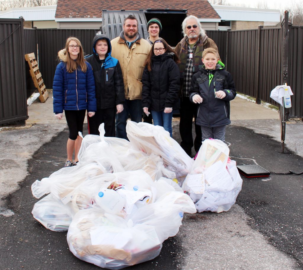 Students at Northwood Elementary School (front, l-r) Meredith Harnden, David Padolesski, Evelynn Smolinski and Reilly Deming worked with the team from Impact Earth, Robert Putney, Elias Putney and Tom Mangialino, on a waste audit. Provided photo. 