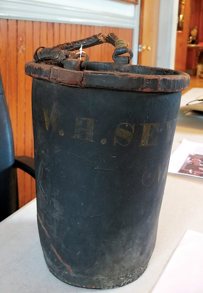 The leather bucket, cc. 1840, has “#4 W.H. Seymour” imprinted. The Village required a fire bucket at each residence to help when the fire alarm sounded. This is the bucket from William Seymour’s own residence. Each family had their own name printed on the bucket. 