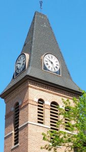 Two of the four clock faces on the Brockport United Methodist Church steeple seen from the corner of Main and State Streets in front of St. Luke’s Episcopal Church.
