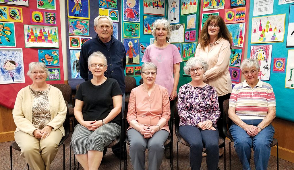 Attending the May 21 Friends of Seymour Library meeting were (l to r) - seated: Charlotte Wright, Debbie Cody, Carolyn Mundy, Linda Sanford, and Mary Marone. Standing: Dan Burns, Lynne Gardner and Karen Sweeting. The photo was taken in the Seymour Library Duryea Room against a background of art work by Mrs. Della Buzard’s art students at the Cornerstone Christian Academy in Brockport. Art work from the community is often displayed here, contributing to the library’s unofficial identity as a “community center.” Photo by Dianne Hickerson 
