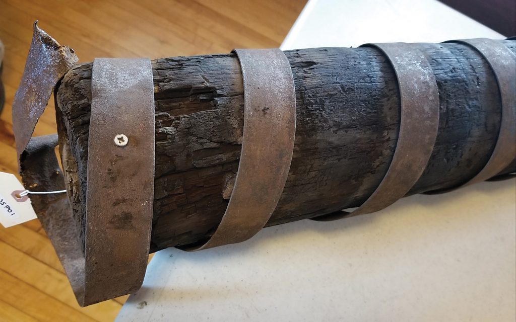 Wooden water mains ran underground to fire hydrants in Brockport. This one was found in Rochester. It is a log hollowed out to about three inches in diameter and wrapped with metal strap reinforcement. Photos by Dianne Hickerson 