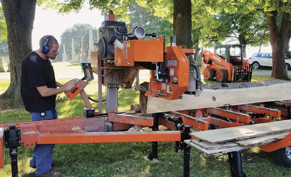 Richard Jurzysta operates the “Woodmizer LT35” full hydraulic saw that turns lumber into beams, mantles, and other things. The horizontal band saw moves along a stationary log at a specified thickness.