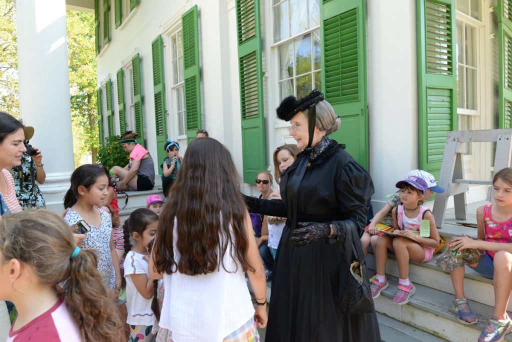 Suffragette speaking to children in the village. 
