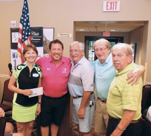 Emcee Dino KJay (second from left) with mixed foursome team winners (l-r) Mary Sperr, Ron Brand, John Nowixki and Jerry Loomis. 