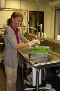 Carol Burchfield prepares fresh produce in the Byron-Bergen Jr./Sr. High School Kitchen. Photo by Susan Kuszlyk