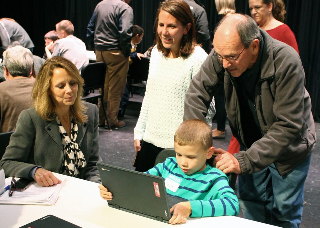 CRS student demonstrates learning applications to his family and to District Superintendent Lori Orologio. Provided photo