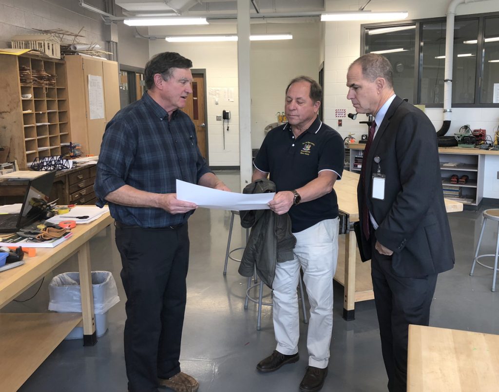 Hawley_tech –  From left, Technology teacher Tim Rogers shows Assemblyman Steve Hawley and Superintendent Brian Bartalo the blueprint for a project Rogers’ Geometry in Construction class is working on. 