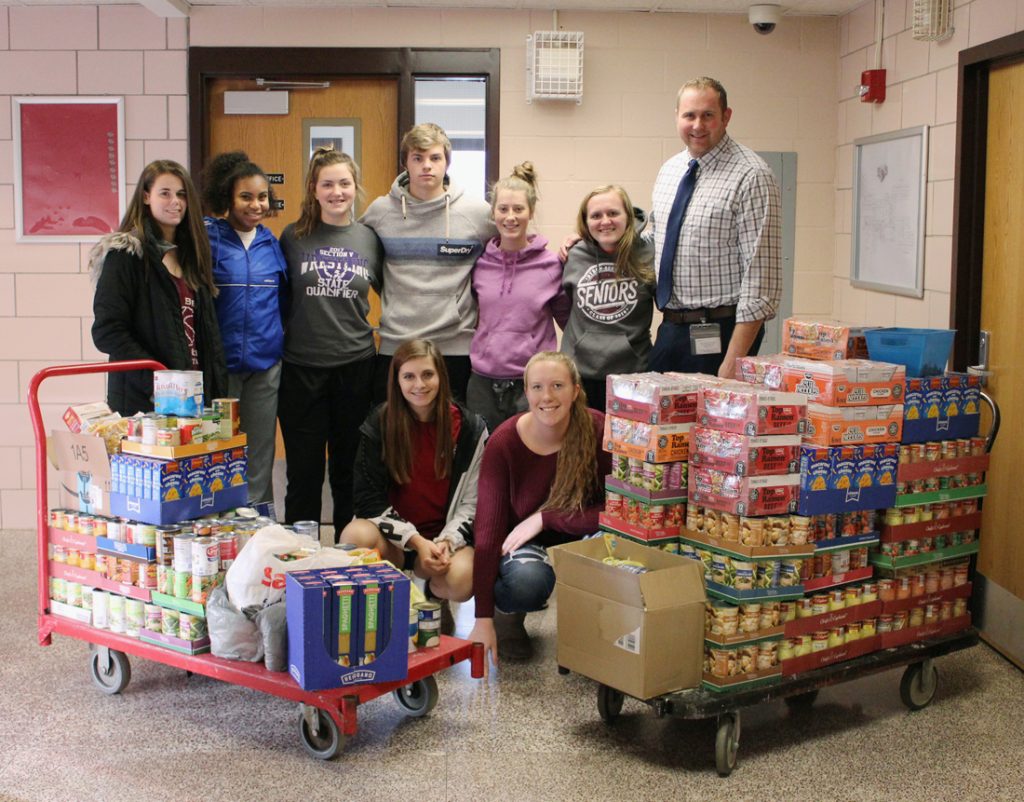 Byron-Bergen Varsity Club members with a few of the hundreds of donated items collected for the Holiday Food Drive.