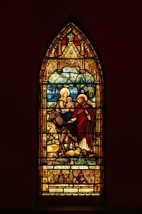 Mary Jane and Daniel Holmes commissioned the stained-glass window Flight Into Egypt, which was crafted in antique glass and painted in England circa 1890. It is one of 14 stained glass windows which tell the story of the life of Jesus and include five windows created by Louis Comfort Tiffany. 
