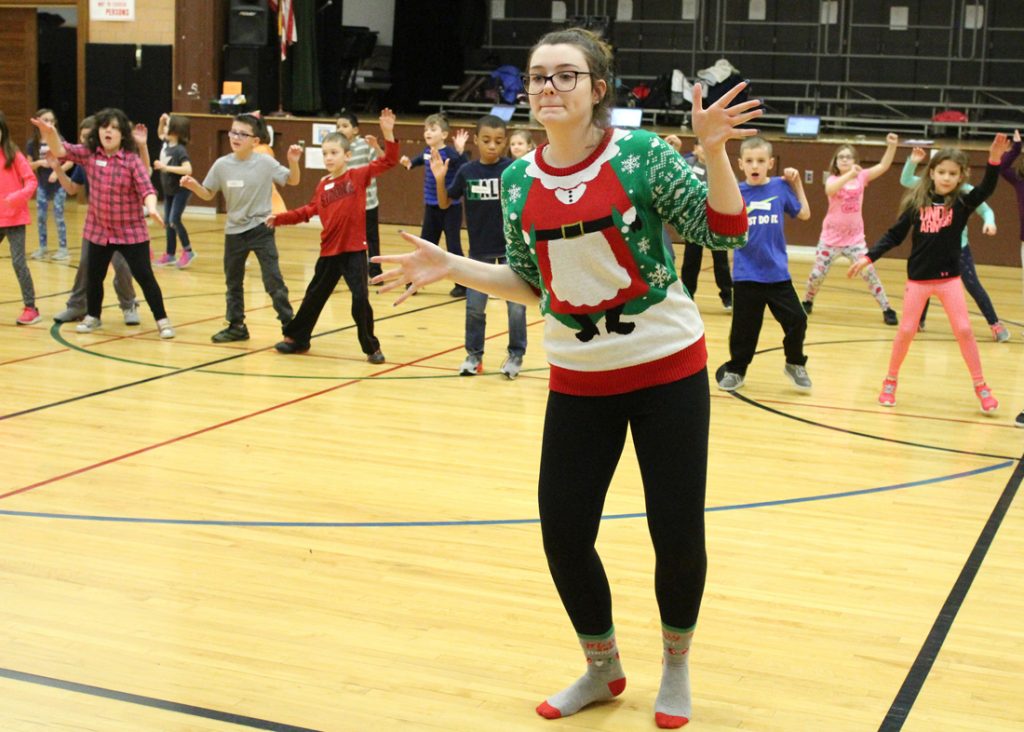 Jasmine Wood teaches CES second-graders a holiday dance routine. 