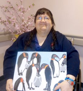Julia Gibbs with her winning painting “The Penguin Family.” Provided photo