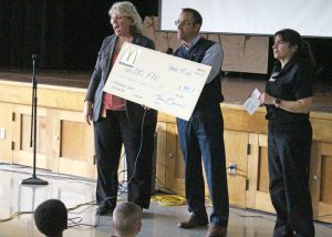 Principal Kim Hale (left) accepts a check from local McDonald’s owner Louis Buono and restaurant manager Kelli Harmor.