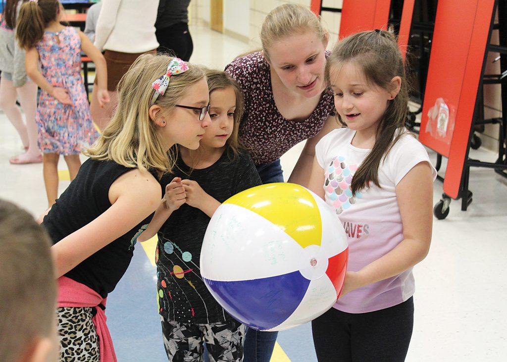 RIT student Allie Zeznick works on a getting-to-know-you activity with second-graders at Churchville Elementary.
