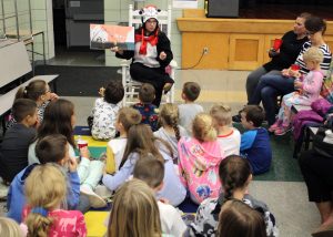 A Dr. Seuss book being read by the Cat in the Hat (librarian Colleen Wilson).