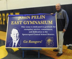 The Spencerport Central School District officially dedicated the high school east gymnasium to retired athletic director, John Pelin, on Friday, December 6.