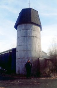 Joe Freitas proudly stands beside the silo he saved.