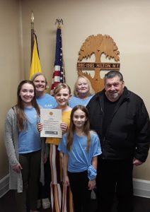 Several ERW Society members meet with Mayor Joseph M. Lee to receive a proclamation celebrating Kids Helping Kids. Tiana Walts, society president, holds the signed Proclamation.