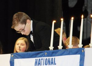 Blake Mott signs the National Junior Honor Society registry as he is inducted into the Hilton Chapter.