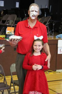 Principal Dave Johnson with his daring student pie thrower Ava.