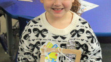 Preschooler holding art