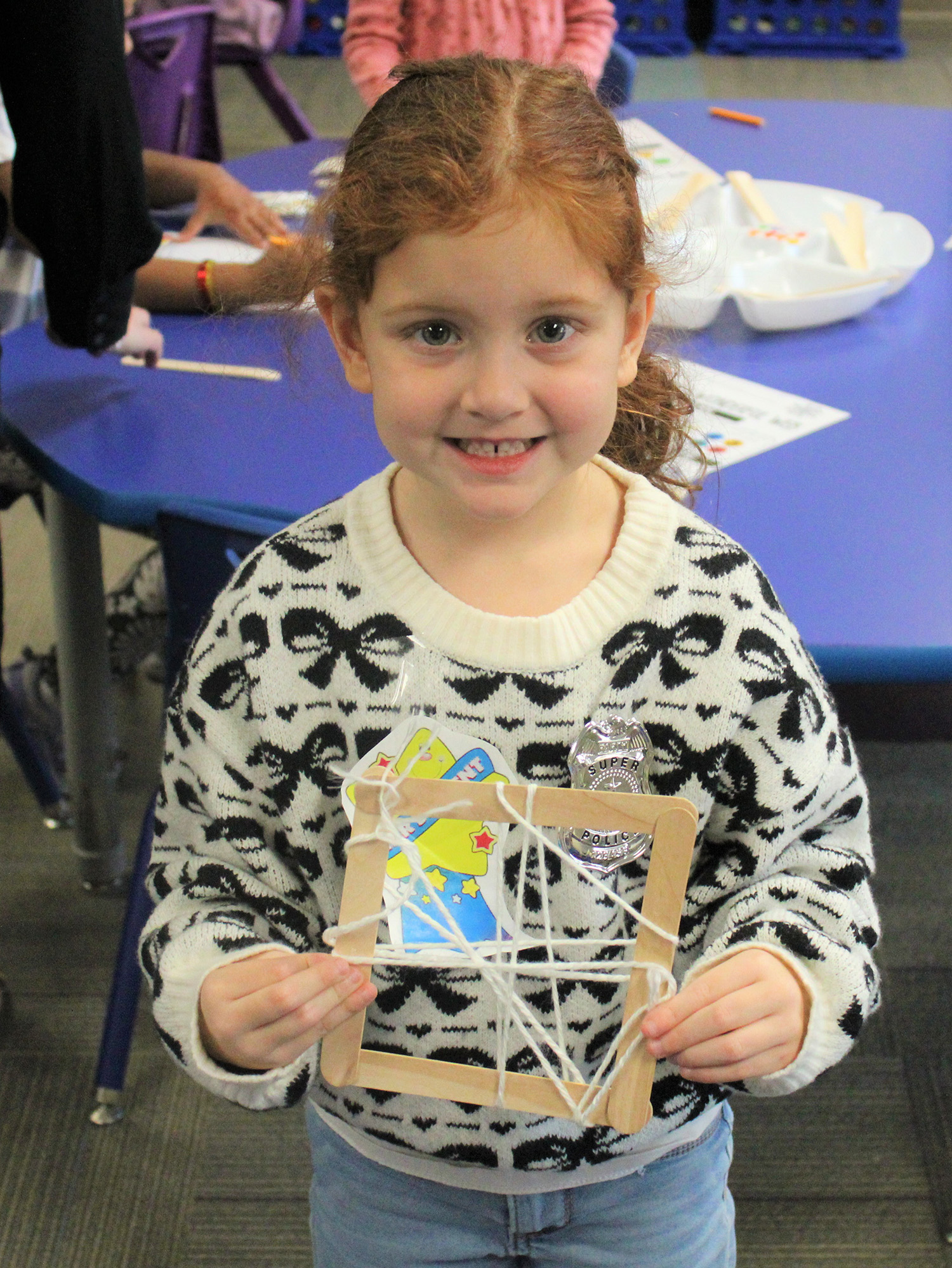 Preschooler holding art